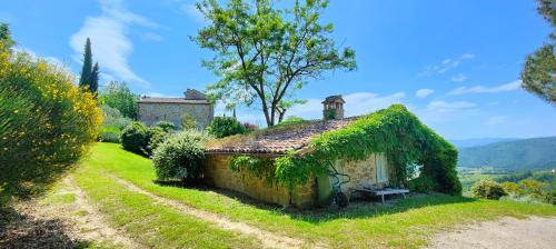 an old house with ivy on it in a field at Infinity pool villa - Fonte Piccola in Città di Castello