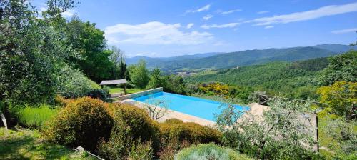 a swimming pool in the middle of a mountain at Infinity pool villa - Fonte Piccola in Città di Castello