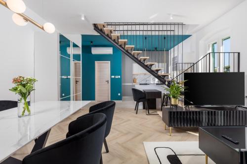 a living room with blue walls and a staircase at Apartments Madeleine in Rijeka