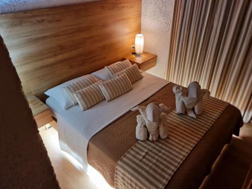 a bedroom with a bed with two stuffed animals on it at Villa Gala in Balíon