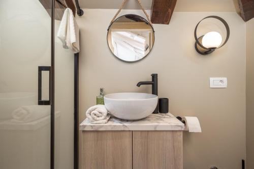 a bathroom with a bowl sink and a mirror at Apartments Madeleine in Rijeka