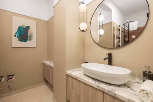 a bathroom with a sink and a mirror at Apartments Madeleine in Rijeka