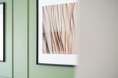 a picture hanging on a wall in a room at Oasis Airport Studios by RevalHome in Tallinn