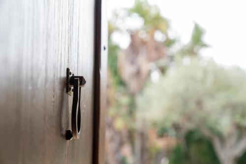a close up of a wooden door with a window at B&B La Manica in Milazzo