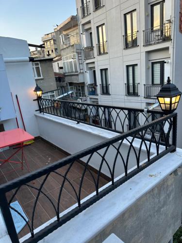 a balcony with a red chair and a building at Center of city in Beşiktaş 2 plus 1 with 2 Bathroom and 3 Air Conditioner in Istanbul