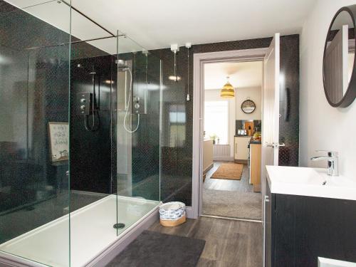 a bathroom with a glass shower and a sink at Upper Deck in Saint Erth