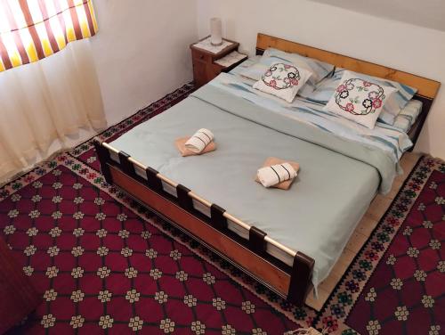 a bedroom with a bed with two pillows on it at Central Rustic House in Žabljak