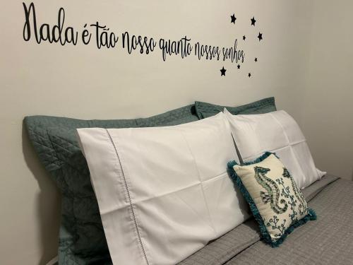a bedroom with a bed with a sign on the wall at BORA BORA RESIDENCE in Joinville