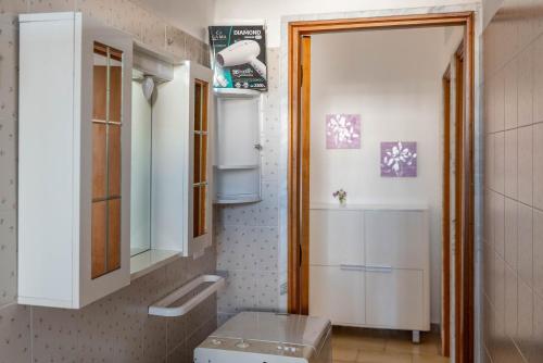 a bathroom with a toilet and a sink and a mirror at BED BIANCANEVE Miniappartamento in Villanova di Ostuni