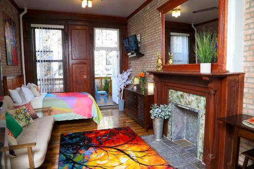 a living room with a bed and a fireplace at The Harlem Getaway in New York