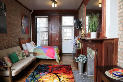 a living room with a bed and a couch at The Harlem Getaway in New York