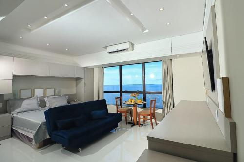 Tropical Executive 1307 With View في ماناوس: غرفة نوم بسرير وطاولة مع كرسي ازرق