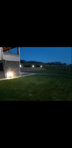 a view of a field of grass with a building at Apartmani Milosavljević in Kuršumlija