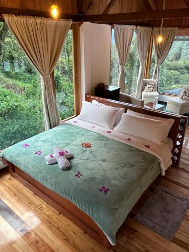 a bedroom with a bed with two stuffed animals on it at La Casa de Martin in Baños
