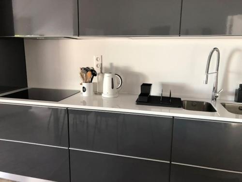 a kitchen with black and white cabinets and a sink at SUNSEA HOUSE in Altares