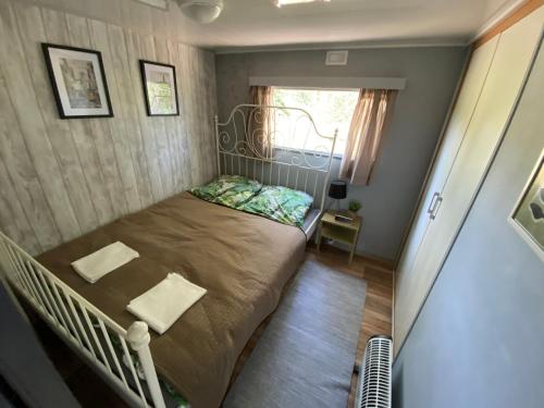 ein kleines Schlafzimmer mit einem Bett und einem Fenster in der Unterkunft Ostoja in Lucień