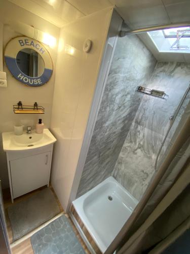 a small bathroom with a shower and a sink at Ostoja in Lucień