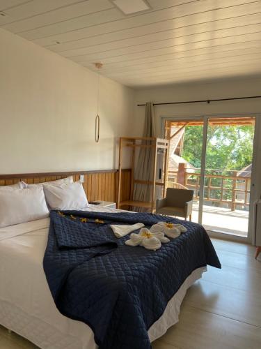a bedroom with a bed with towels on it at Pousada do Nativo in Fernando de Noronha