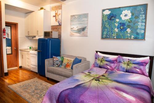 een woonkamer met een bed en een keuken bij The Harlem Getaway in New York