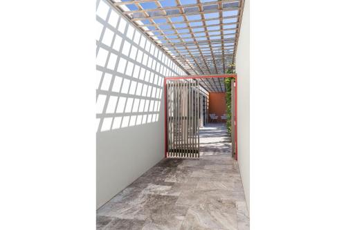 an open gate in a building with a glass ceiling at Boofs At Blueys in Blueys Beach