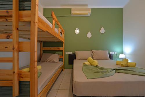 a bedroom with two bunk beds and a ladder at Studios Λύδια in Paralía Skotínis