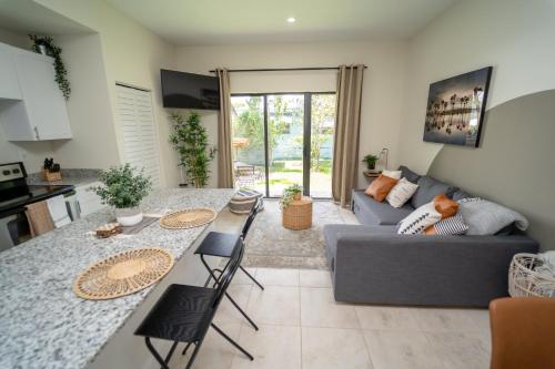 a living room with a gray couch and a table at Miami Luxury Vacation! Next to Wynwood & Design district in Miami