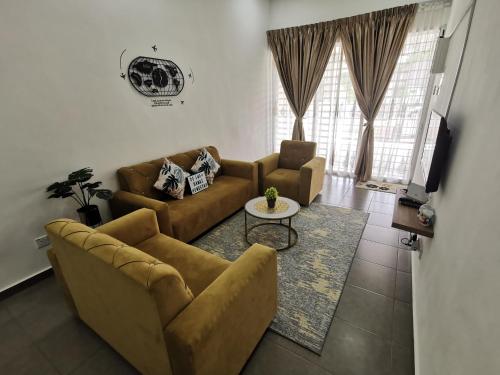 a living room with two couches and a table at De'Sara Damai Homestay, Kuantan in Kuantan
