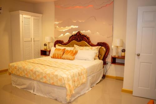 a bedroom with a bed with a cloud painted on the wall at Escappé Suites 