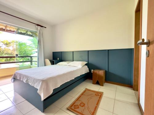 a bedroom with a large bed and a balcony at Breeze 09 Imbassaí in Imbassai