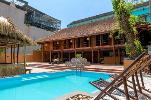 a resort with a swimming pool and a building at Odyssey Hostel, Tours & Motorbikes Rental in Ha Giang