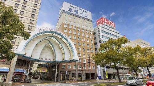 a building with an arch in the middle of a street at Toyoko Inn Takamatsu Hyogomachi in Takamatsu