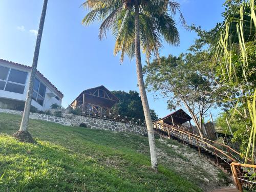 a resort with palm trees and a building at bacalar My Love Front Laguna in Bacalar