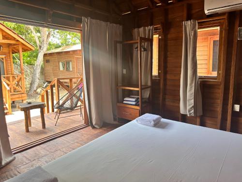 a bedroom with a bed and a large window at bacalar My Love Front Laguna in Bacalar