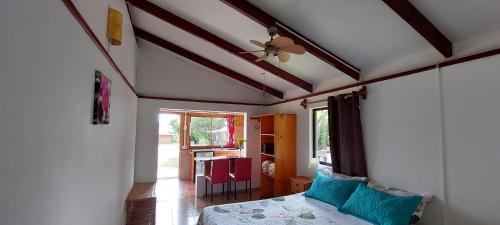 a bedroom with a bed and a ceiling fan at Merahi House Cabañas I in Hanga Roa