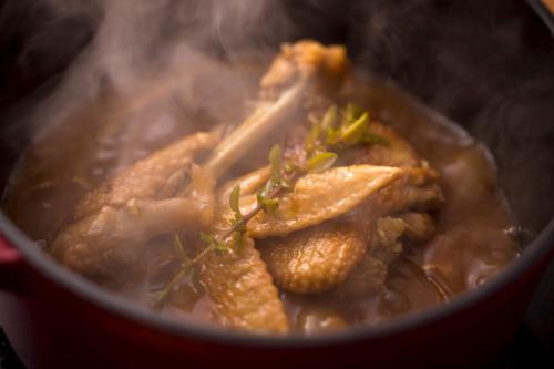 a pot of food with meat and vegetables in it at Kisara Oneness in Toba