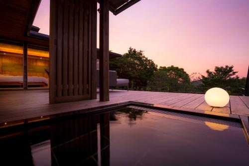 a pool with a lamp next to a house at Kisara Oneness in Toba