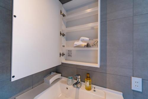 a bathroom with a sink and a mirror at LEO Resort Sunayama in Miyako Island