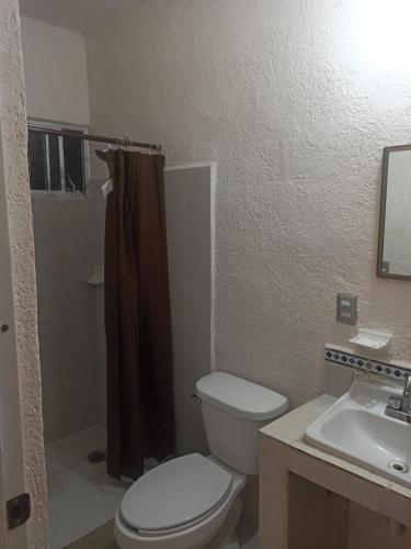 a bathroom with a toilet and a sink at Casita Mahahual 2, Grand Costa Maya in Mahahual