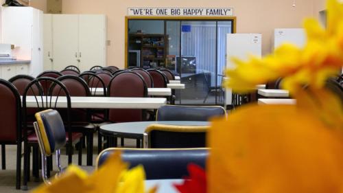 a dining room with tables and chairs and yellow flowers at Preferred RV Resort in Pahrump