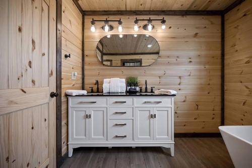 a bathroom with a white vanity and a mirror at Modern Riverfront, Starlink, Hot Tub, Broken Bow in Wright City