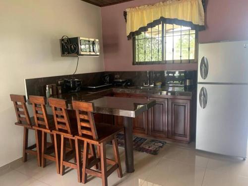a kitchen with a table and chairs and a refrigerator at Casa RODME in Fortuna