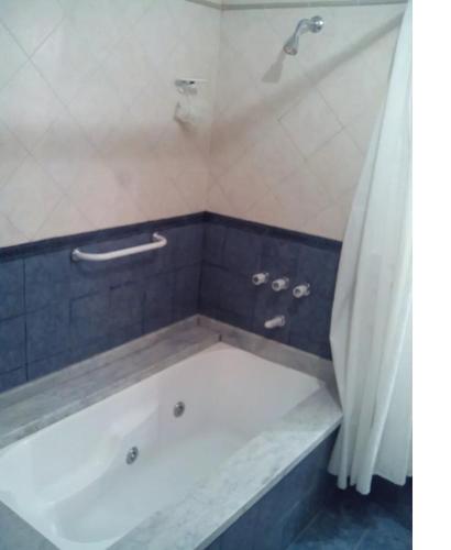 a bath tub in a bathroom with a shower at El lugar in Villa Gesell