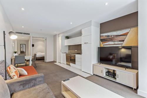 a living room with a large flat screen tv at Belle Escapes - Glenelg Shores Apartment in Glenelg