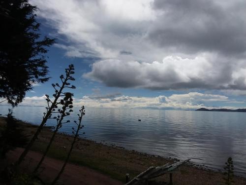 a view of a body of water with a cloudy sky at Kasa Kultural Sol y Luna in Copacabana