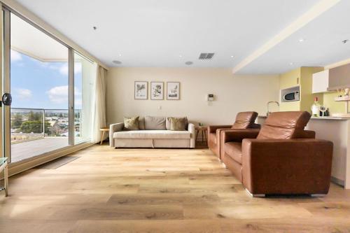 a living room with two couches and a large window at Belle Escapes - Olive Retreat at Glenelg in Glenelg