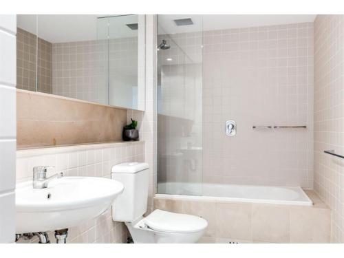 a bathroom with a toilet and a sink and a shower at Belle Escapes - Absolute Ocean Views in Glenelg