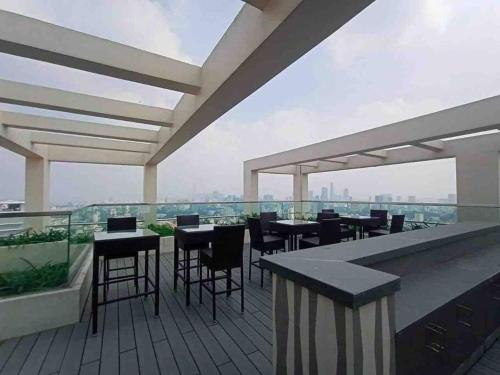 a balcony with tables and chairs on a building at Lynhapartment The Tresor Saigon Disctrict 4 in Ho Chi Minh City