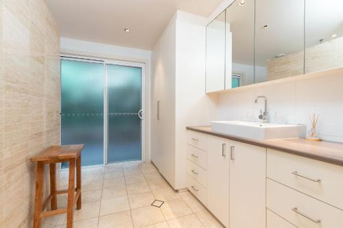 a bathroom with a sink and a shower at Iluka at Blueys Beach in Blueys Beach