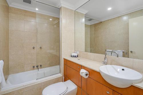 a bathroom with a sink and a toilet and a tub at Chelsea Terrace in Newcastle
