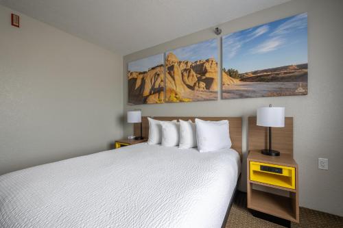 a hotel room with a bed and paintings on the wall at Days Inn by Wyndham Wall in Wall